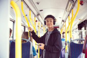 Boy with mobile phone traveling in bus